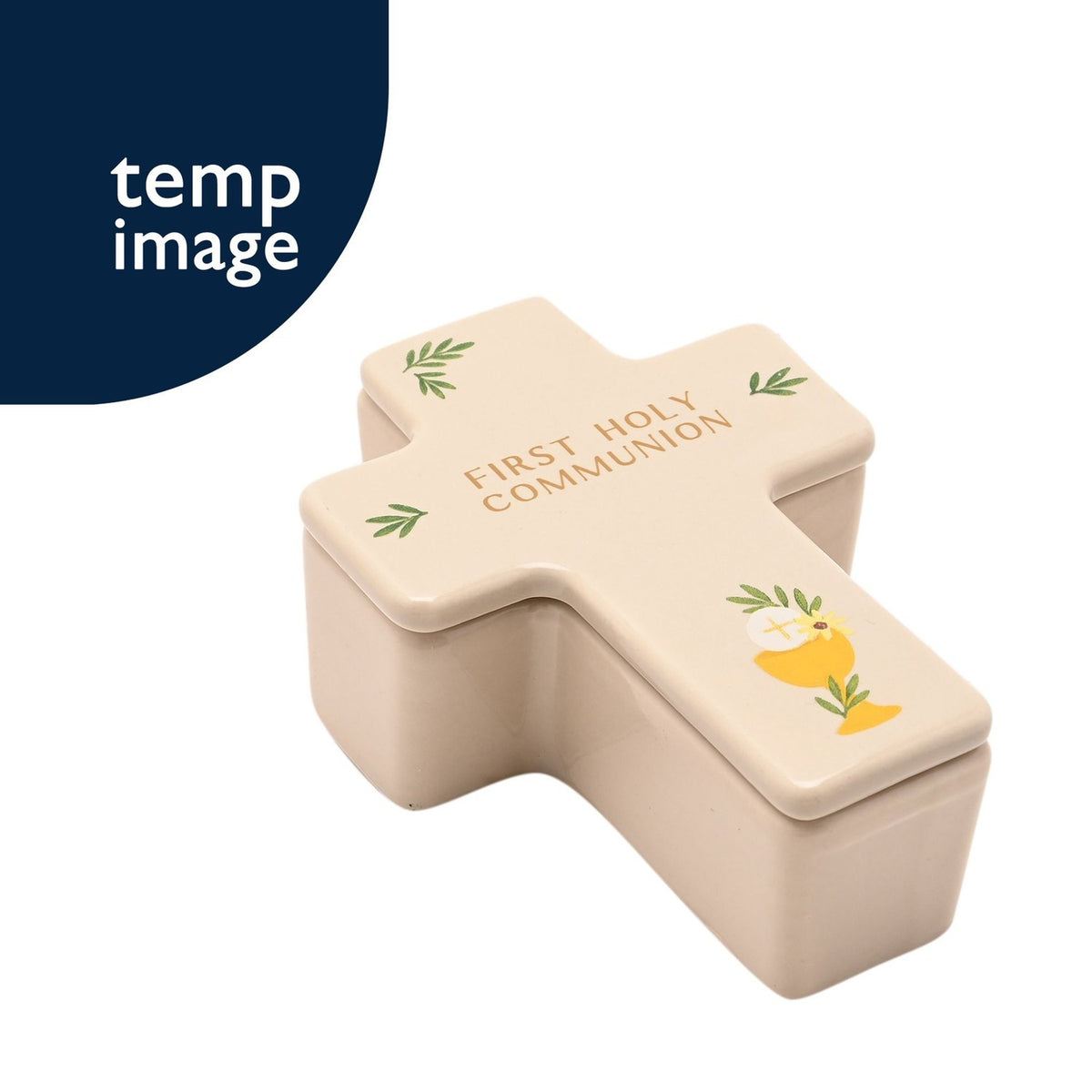 Cream ceramic cross-shaped trinket box with lid, reading "First Holy Communion" in gold text, decorated with a chalice, host, and green leaf motifs on a white background.