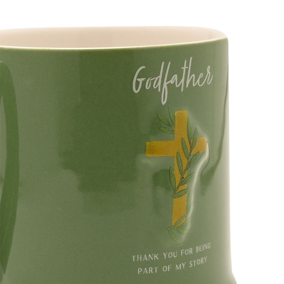 Close-up of green stoneware Godfather mug with cream rim, featuring a raised gold cross and leaf design above "Thank You For Being Part Of My Story" text.