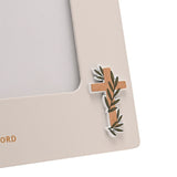 Close-up of the Confirmation Girl Wooden Photo Frame corner in off white, showing a raised cross with olive branch detail and gold capital lettering.
