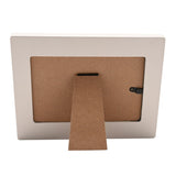 Back view of the Confirmation Girl Wooden Photo Frame 6 x 4in in off white, showing the kraft-board back panel, fold-out easel stand, and hinged closure on a plain white background.