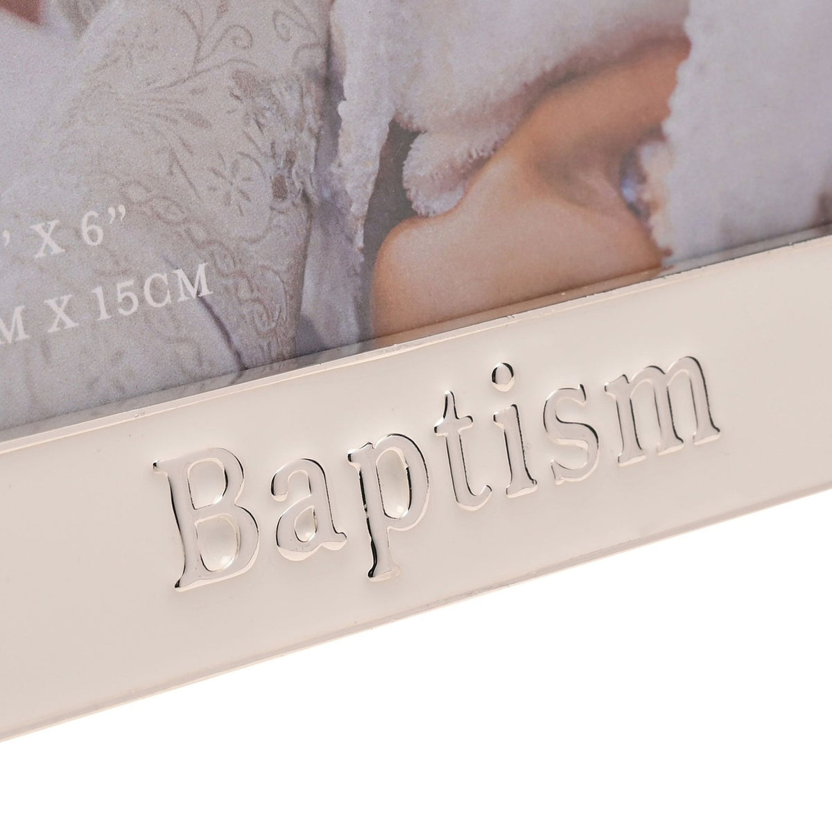Close-up of the white enamel Baptism photo frame showing raised silver "Baptism" lettering on the bottom band with silver trim along the edge.