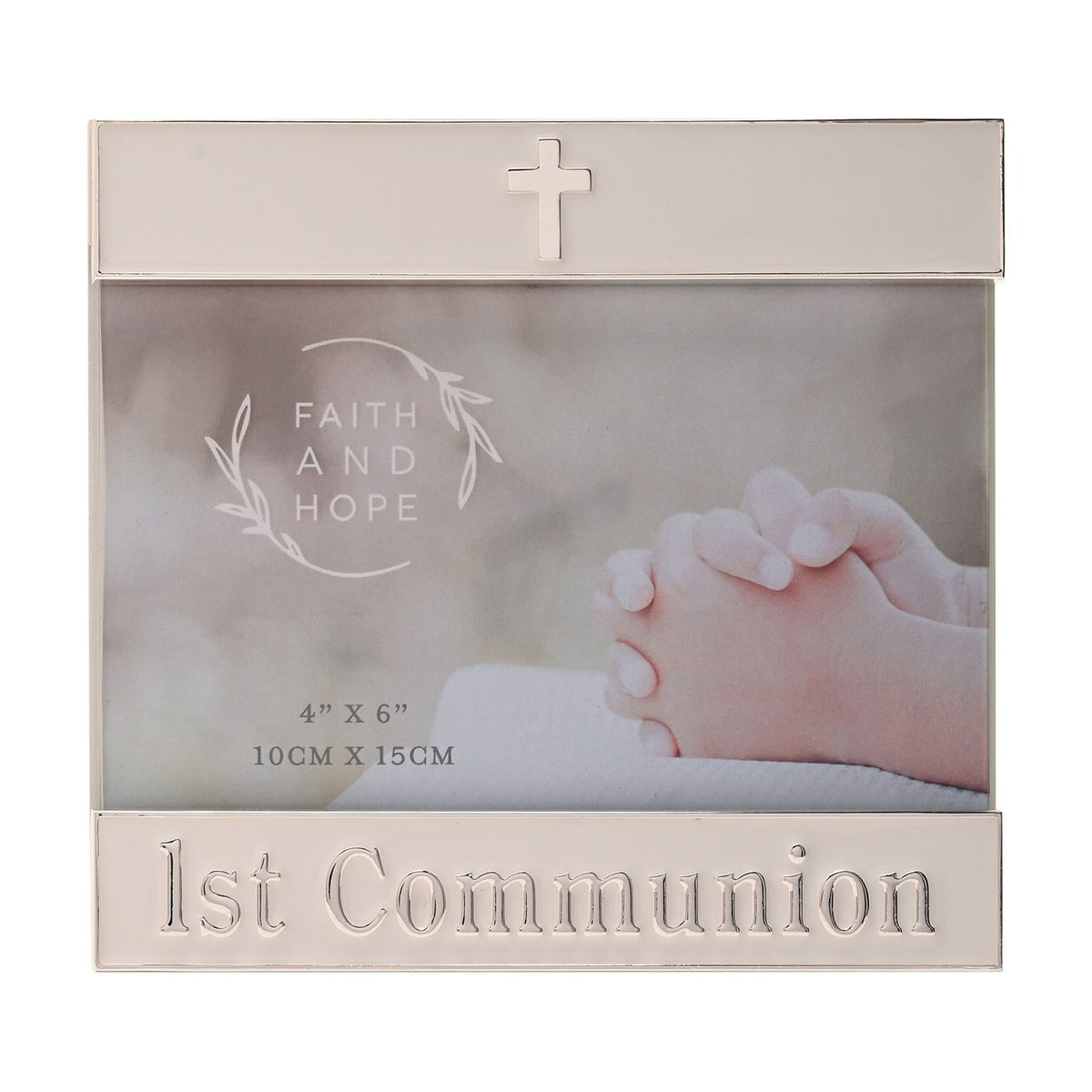White enamel metal photo frame with silver trim, a small cross on the top bar and "1st Communion" lettering on the lower bar, holding a 4"x6" photo.