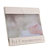 White enamel metal photo frame with silver trim, a small cross on the top bar and "1st Communion" lettering on the bottom bar, shown on a white background.