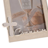 Close-up of a cream enamel metal photo frame with silver trim, featuring a raised silver cross and "Communion" script along the lower edge, holding a 4"x6" faith-themed photo.