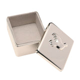 Rectangular silver metal keepsake box with a raised dove design on the polished lid, shown open to reveal a grey velvet-lined interior, on a white background.