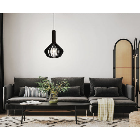 Filbessa wooden pendant light in black, single-bulb cage shade with vertical slats, hanging above a grey sofa in a living room setting.