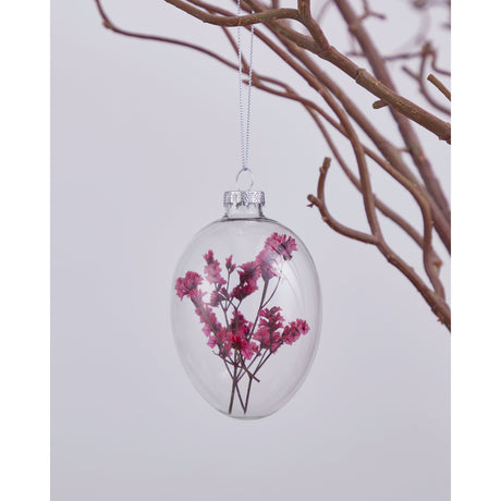 Fintry Decorative Egg in clear glass with pink dried flower sprigs inside, silver cap and hanging loop, shown on a twig branch against a light background.