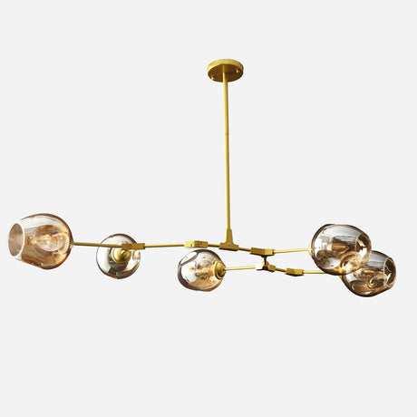 The Tree 5 Light Suspension - Gold is a contemporary luxury chandelier with a gold finish metal frame, featuring five spherical glass shades that each house a light bulb, gracefully suspended from a central rod against a white backdrop.