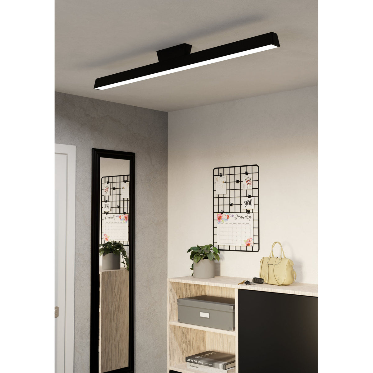 Flanvorne Smart LED flush ceiling light in black, a slim linear bar with white diffuser and central mount, shown illuminated on a hallway ceiling above a mirror and console.