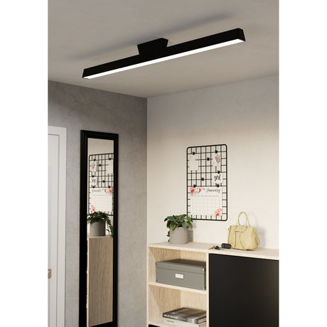 Flanvorne Smart LED flush ceiling light in black, a slim linear bar with white diffuser and central mount, shown illuminated on a hallway ceiling above a mirror and console.