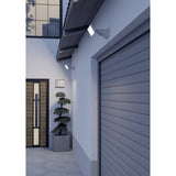 Flenvenne LED Flood Light in white mounted beside a garage door and above an entrance, with its rectangular panel angled on an adjustable bracket for outdoor security lighting.