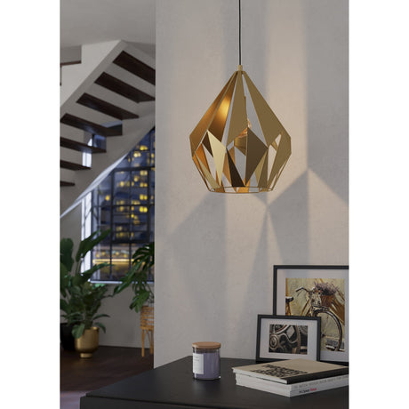 Flermanne Pendant Light 38.5cm in gold, a faceted steel cage-style shade on a black cord, shown hanging above a dark console table in a hallway setting.