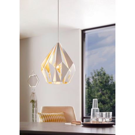 Flermanne pendant light with a faceted white steel shade and honey gold interior, E27 bulb visible, hanging above a dining table near a window.