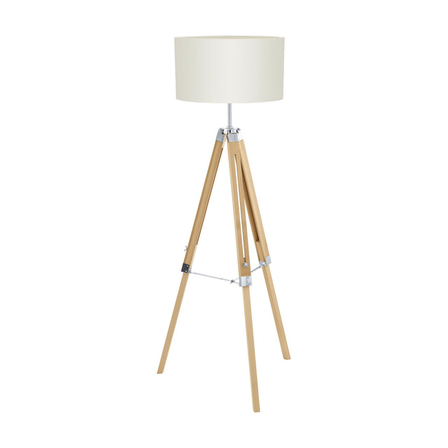 Flivelle Floor Lamp tripod with natural wood legs, chrome fittings and cross brace, and a wide beige fabric drum shade, on a plain white background.