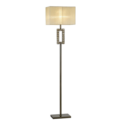 The Florence Rectangle 1 Light Crystal Floor Lamp features a brass slim metal stand, a decorative geometric section with crystal accents near the top, and a modern cream rectangular shade. It is dimmable for customizable lighting.