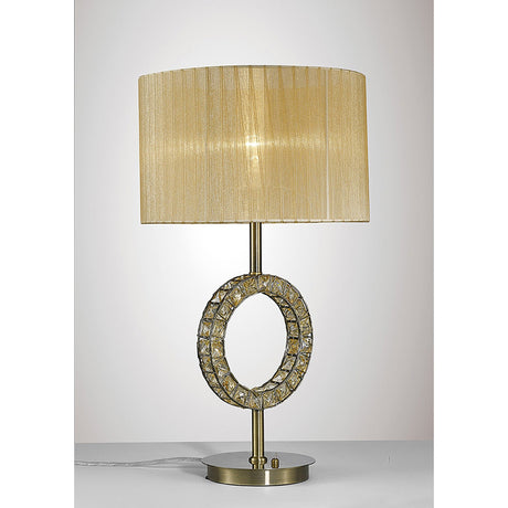 The Florence Round 1 Light Crystal Table Lamp features a brass cylindrical base, crystal-accented circular ring, and a soft bronze pleated shade, displayed on a white surface against a light backdrop.