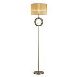 The Florence Round 1 Light Crystal Floor Lamp features a tall, slender brass stand, a decorative circular accent below the bronze shade, and a round base.
