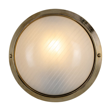 Florina Bulkhead round wall light with ribbed frosted glass dome in a brass ring frame, visible mounting screws, illuminated bulb, on a plain white background.