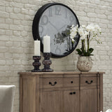 Hill Interiors Large Stone Potted Orchid With Roots displayed on a wooden sideboard beside candle holders, beneath a round black wall clock.