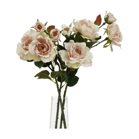 Hill Interiors Palest Blush Tea Rose faux stems with soft pink layered blooms, buds and green foliage arranged in a clear glass vase on a white background.