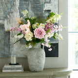 Hill Interiors White Peony faux stem displayed with pink dahlias and mixed blooms in a textured stone vase on a console table beneath abstract art.