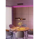 Folcino Smart Colour Changing Pendant Light in bronze and black, with angled aluminium arms suspended on fine wires above a wooden dining table.
