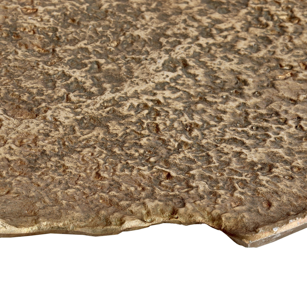 Close-up of the Forleyet decorative bowl's edge in aluminium with an antique brass finish, showing hammered, pitted texture and an irregular rim on a white background.
