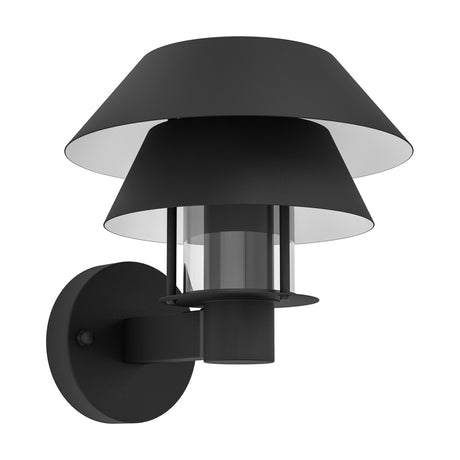 Fornena outdoor wall light with two stacked black conical shades, white undersides, and a clear glass cylinder in a black cage on a round wall-mounted plate, shown against a plain white background.