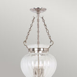 The Finsbury Park 3 Light Medium Chandelier in Polished Nickel is a contemporary chandelier featuring a clear glass globe, polished nickel accents, and a modern design with visible light bulbs. It is suspended by two metal chains.