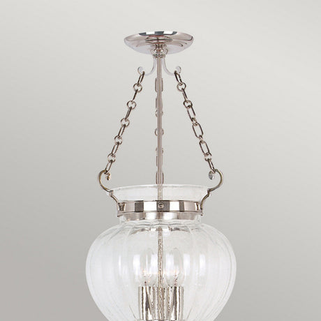 The Finsbury Park 3 Light Medium Chandelier in Polished Nickel is a contemporary chandelier featuring a clear glass globe, polished nickel accents, and a modern design with visible light bulbs. It is suspended by two metal chains.