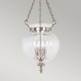 The Finsbury Park 3 Light Medium Chandelier in Polished Nickel showcases an elegant, ribbed glass design that hangs from a sleek nickel chain fixture. Inside, the chandelier features multiple candle-style lights for a classic touch against the neutral gray background.