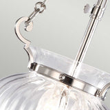 This elegant close-up showcases the Finsbury Park 3 Light Small Chandelier in Polished Nickel. Featuring a ribbed glass shade, polished nickel top, chain, and decorative hook, this design exudes modern sophistication—ideal for those seeking a refined touch in their space.