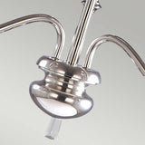 Close-up of the Finsbury Park 3 Light Chandelier in polished nickel, featuring gracefully curved arms and a central stem, set against a light gray background. The metal surface shines brilliantly, beautifully reflecting the light.