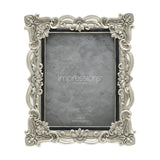 Antique-style rectangular resin photo frame in silver with scrollwork, floral details and crystal accents at each corner, holding a 6x8in photo on a white background.