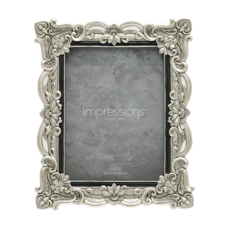 Antique-style rectangular resin photo frame in silver with scrollwork, floral details and crystal accents at each corner, holding a 6x8in photo on a white background.