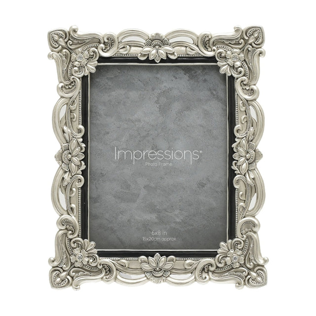 Antique-style rectangular resin photo frame in silver with scrollwork, floral details and crystal accents at each corner, holding a 6x8in photo on a white background.