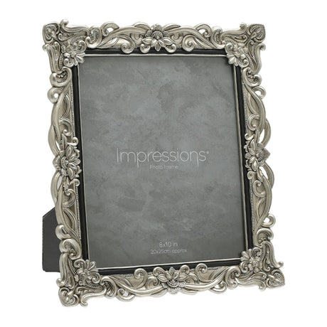 Antique-style rectangular photo frame in silver resin with raised floral scrollwork and crystal accents at the corners, a slim black inner edge, and a grey insert, shown on a white background.