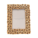 Rectangular resin photo frame with a raised gold floral border of overlapping blossoms, shown upright with sample insert on a white background.