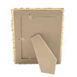 Back view of the Flowers Design Resin Photo Frame in gold, showing the fold-out easel stand and fabric-lined backing with photo insert slot, on a plain white background.