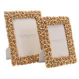 Two gold resin photo frames with raised floral borders in 5x7 in and 4x6 in sizes, each with an easel back, shown on a plain white background.