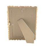 Back view of the Flowers Design Resin Photo Frame in gold, showing the fold-out easel stand, rectangular opening, and screw fittings on a plain white background.