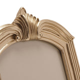 Close-up of the Winged Arch Resin Photo Frame in champagne, showing the arched top with a fanned, ridged leaf crest and scrolled sides against a plain white background.
