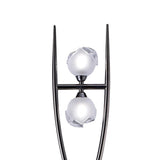 The Fragma 4 Light Floor Lamp - Black features two white spheres held between sleek prongs, each sphere partially enclosed by clear, angular accents—evoking the look of a modern metal sculpture against a plain white background.