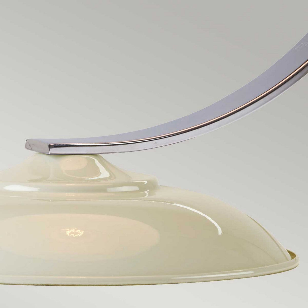 Close-up of the Franklin Desk Lamp - White, showcasing its curved metal arm and smooth, glossy white shade, ideal for task lighting. The background enhances modern interiors with its neutral gray tone.