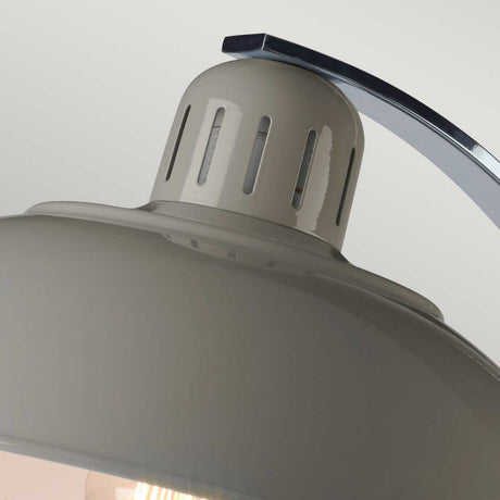 Close-up view of a gray industrial-style pendant light featuring a vented cap and metallic arc, providing focused task lighting. The smooth finish complements its modern aesthetic, reminiscent of the sleek design seen in the Franklin Desk Lamp - Grey against a neutral backdrop.