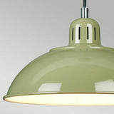 A close-up of the Franklin Pendant Light - Green showcases its retro-inspired charm with a light green, glossy finish. The lamp is illuminated, providing a warm glow that serves as ideal task lighting against a neutral gray background.