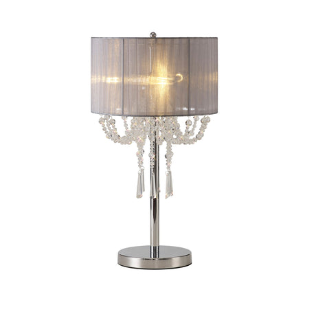 The Freida 3 Light Crystal Table Lamp features a polished chrome base, a grey cylindrical organza shade, and decorative crystal beads and pendants that glow elegantly when lit.