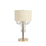 The Freida 3 Light Crystal Table Lamp features a French gold round base, luxury accents, an ivory cream shade, and elegant crystal bead strands hanging beneath the organza.