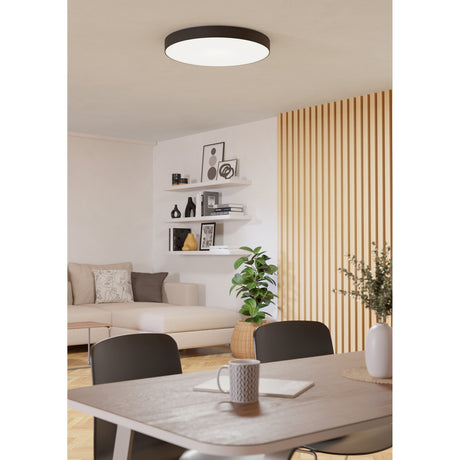 Frelvine Smart LED Flush Ceiling Light 69cm in black, round drum design with white diffuser, shown on a dining and living room ceiling.
