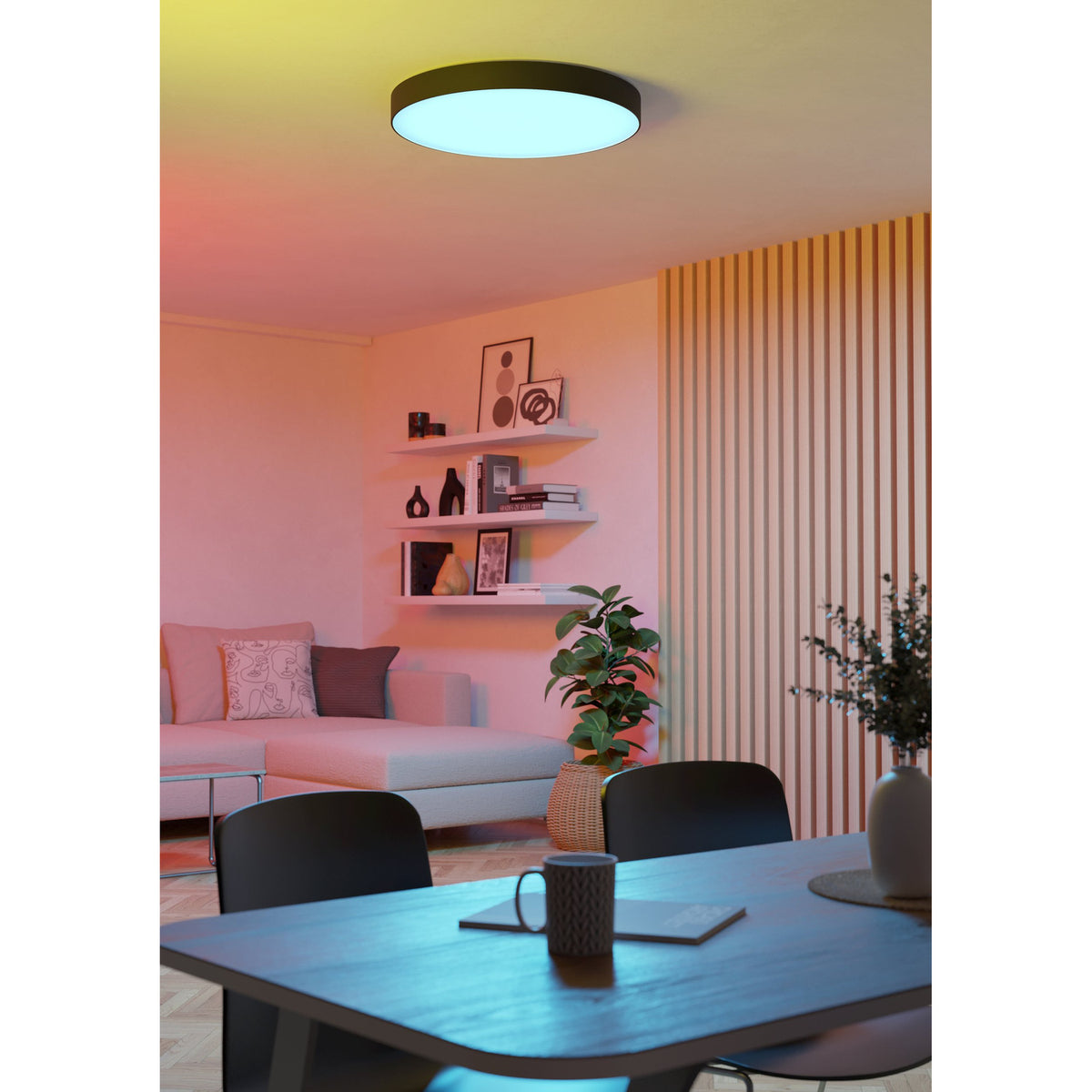 Frelvine Smart LED Flush Ceiling Light 69cm in black, round drum design with white diffuser, shown glowing in a dining area casting coloured ambient light.